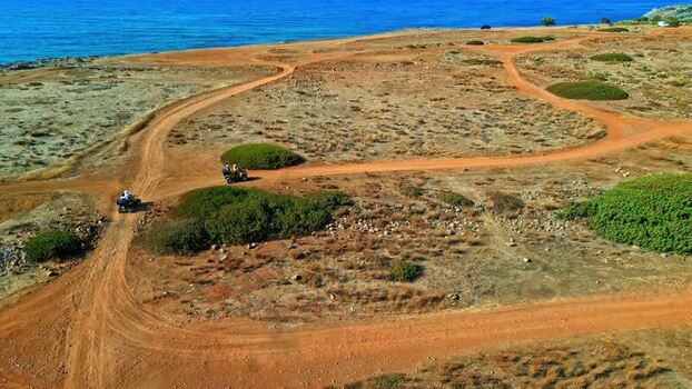 Aerial view of ATVs on a dirt path in Crete Greece.