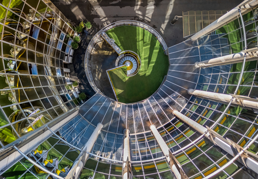 Aerial view of a modern glass building featuring a circular courtyard with a spiral staircase and green space in Belgrade City of Belgrade Serbia. Aerial view of a modern glass building featuring a circular courtyard with a spiral staircase and green space in Belgrade City of Belgrade Serbia.