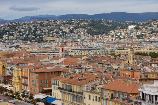 Aerial view of the historic city of Nice with its dense collection of terracotta rooftops traditional Mediterranean architecture and distant hills in Nice Provence Alpes Cote d Azur France. Aerial view of the historic city of Nice with its dense collection of terracotta rooftops traditional Mediterranean architecture and distant hills in Nice Provence Alpes Cote d Azur France.
