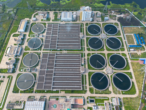 Aerial view of the Sewage Treatment Plant Dhaka WASA featuring circular sedimentation tanks and rectangular basins surrounded by greenery in Dhaka Dhaka Division Bangladesh. Aerial view of the Sewage Treatment Plant Dhaka WASA featuring circular sedimentation tanks and rectangular basins surrounded by greenery in Dhaka Dhaka Division Bangladesh.