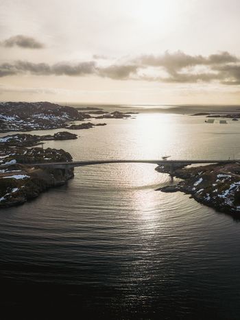 Aerial view of the bridge over the dark waters under the cloudy sky Kåkernbrua Nordland Norway. Aerial view of the bridge over the dark waters under the cloudy sky Kåkernbrua Nordland Norway.