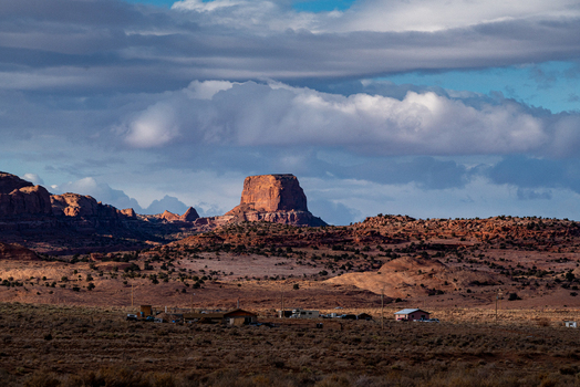View of Monument Valley Tribal Park featuring iconic red rock buttes and desert landscape under a dramatic cloudy sky in Oljato Monument Valley Utah United States.