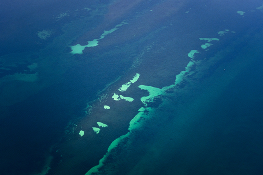 Aerial view of the turquoise shallows and deep blue waters of the ocean patterns in the Shire of Shark Bay Western Australia Australia. Aerial view of the turquoise shallows and deep blue waters of the ocean patterns in the Shire of Shark Bay Western Australia Australia.