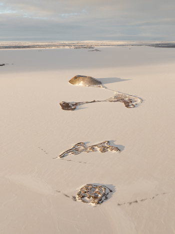 Aerial view of the frozen Lake Myvatn with its distinctive volcanic pseudocraters and snow covered landscape in Thingeyjarsveit Iceland. Aerial view of the frozen Lake Myvatn with its distinctive volcanic pseudocraters and snow covered landscape in Thingeyjarsveit Iceland.