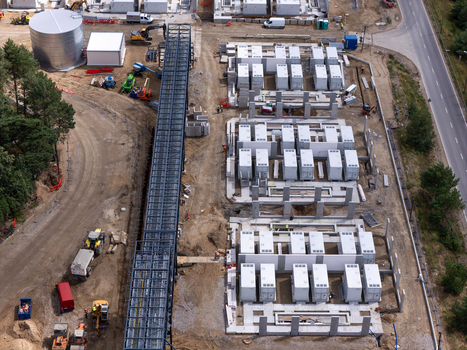 Aerial view of the Zarnowiec Pumped Storage Power Station construction site with battery storage units heavy machinery and a metal gantry in Wejherowo County Pomeranian Voivodeship Poland.