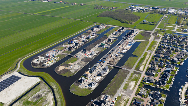 Lemmer Netherlands 21 April 2026 Aerial view of modern houses under construction along artificial waterways surrounded by green fields. Lemmer Netherlands 21 April 2026 Aerial view of modern houses under construction along artificial waterways surrounded by green fields.