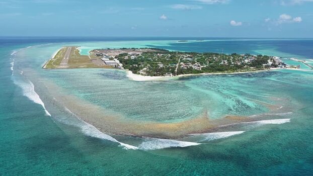 Aerial view of Kudahuvadhoo island and airport runway Maldives.
