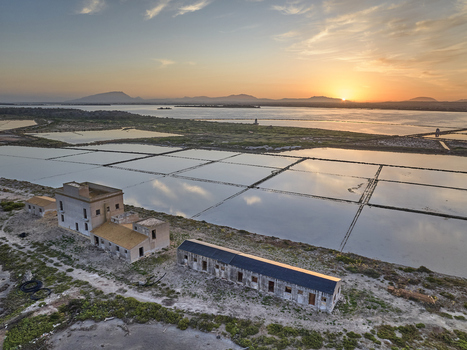 Aerial view of Saline dello Stagnone salt pans at sunset with historic buildings and reflective water pools in Marsala Sicilia Italy. Aerial view of Saline dello Stagnone salt pans at sunset with historic buildings and reflective water pools in Marsala Sicilia Italy.