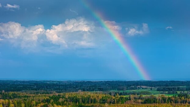 Aerial view of a rainbow over a forest in Latvia. Aerial view of a rainbow over a forest in Latvia.