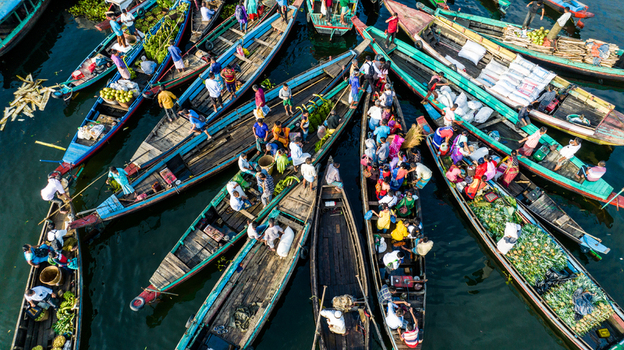 Rangamati Bangladesh 19 October 2022 Aerial view of colorful wooden boats filled with people and goods navigating the water capturing the vibrant daily life at the Rangamati market.