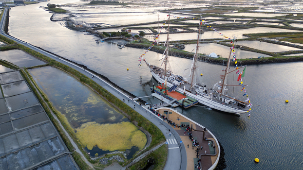 Aerial view of the tall ship NRP Sagres decorated with signal flags navigating the Canal de Aveiro near the salt pans Aveiro Aveiro Portugal. Aerial view of the tall ship NRP Sagres decorated with signal flags navigating the Canal de Aveiro near the salt pans Aveiro Aveiro Portugal.