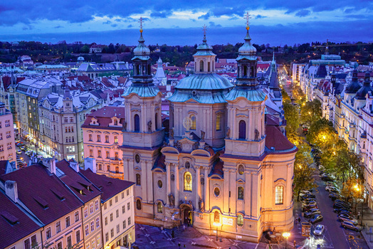 Aerial view of the Baroque St. Nicholas Church in the Old Town Square surrounded by historic buildings and city streets at dusk in Prague Prague Czechia. Aerial view of the Baroque St. Nicholas Church in the Old Town Square surrounded by historic buildings and city streets at dusk in Prague Prague Czechia.