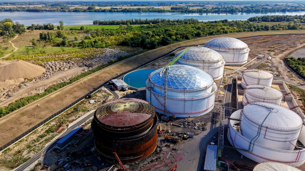Aerial view of industrial fuel storage tanks including white dome shaped reservoirs and one under construction near the river in Kovin Vojvodina Serbia. Aerial view of industrial fuel storage tanks including white dome shaped reservoirs and one under construction near the river in Kovin Vojvodina Serbia.