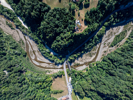 Aerial view of Sodbachbrucke Sense bridge crossing the Sense river surrounded by dense forests and winding roads in Heitenried Freiburg Switzerland. Aerial view of Sodbachbrucke Sense bridge crossing the Sense river surrounded by dense forests and winding roads in Heitenried Freiburg Switzerland.