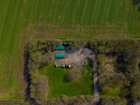 Aerial view of Ladfordfields Industrial Estate featuring industrial buildings surrounding trees and adjacent agricultural fields in Stafford England United Kingdom. Aerial view of Ladfordfields Industrial Estate featuring industrial buildings surrounding trees and adjacent agricultural fields in Stafford England United Kingdom.