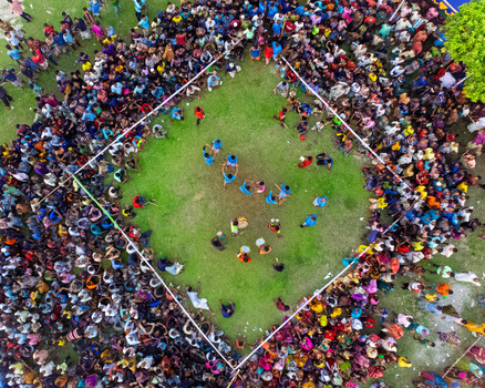 Nilphamari Bangladesh 01 May 2026 Aerial view of a large crowd of people gathered around a square grass field for a traditional sporting event or local festival. Nilphamari Bangladesh 01 May 2026 Aerial view of a large crowd of people gathered around a square grass field for a traditional sporting event or local festival.