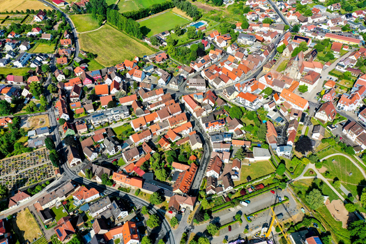 Aerial view of the historic town center featuring traditional red roofed houses narrow streets and lush green gardens Neunkirchen am Brand Bavaria Germany. Aerial view of the historic town center featuring traditional red roofed houses narrow streets and lush green gardens Neunkirchen am Brand Bavaria Germany.