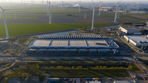 Aerial view of the Google GRQ data center facility surrounded by wind turbines and green fields in Eemshaven Groningen Netherlands. Aerial view of the Google GRQ data center facility surrounded by wind turbines and green fields in Eemshaven Groningen Netherlands.