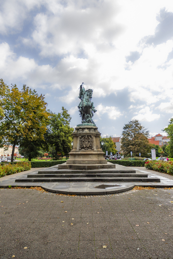 View of the King John III Sobieski Monument a bronze equestrian statue set on a stone pedestal in a park with surrounding trees and paved walkways in Gdansk Pomeranian Voivodeship Poland. View of the King John III Sobieski Monument a bronze equestrian statue set on a stone pedestal in a park with surrounding trees and paved walkways in Gdansk Pomeranian Voivodeship Poland.