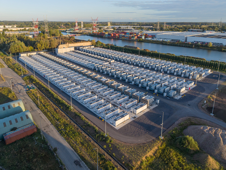 Aerial view of the Cargovil battery energy storage system with rows of white storage units situated near a canal in an industrial area in Vilvoorde Vlaanderen Belgium. Aerial view of the Cargovil battery energy storage system with rows of white storage units situated near a canal in an industrial area in Vilvoorde Vlaanderen Belgium.