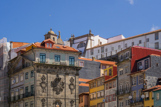 View of vibrant buildings with terracotta roofs and ornate facades rise under a clear blue sky a rich display of architectural heritage Porto Porto District Portugal. View of vibrant buildings with terracotta roofs and ornate facades rise under a clear blue sky a rich display of architectural heritage Porto Porto District Portugal.