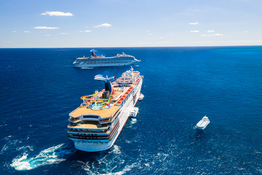 The Berry Islands The Bahamas 02 May 2020 Aerial view of two cruise ships sailing in the deep blue waters of the Atlantic Ocean with clear skies and calm sea conditions.