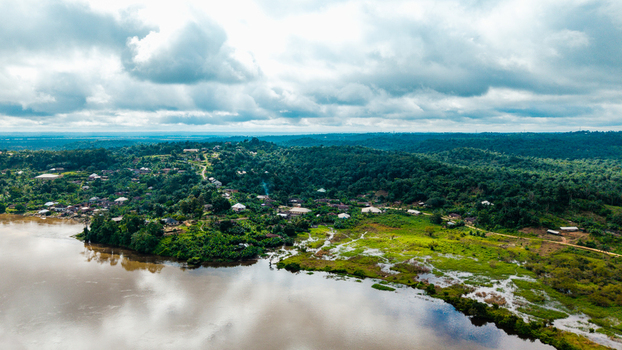 Aerial view of the town of Itu situated along the banks of the Cross River surrounded by lush green tropical vegetation and rolling hills in Itu Akwa Ibom Nigeria. Aerial view of the town of Itu situated along the banks of the Cross River surrounded by lush green tropical vegetation and rolling hills in Itu Akwa Ibom Nigeria.
