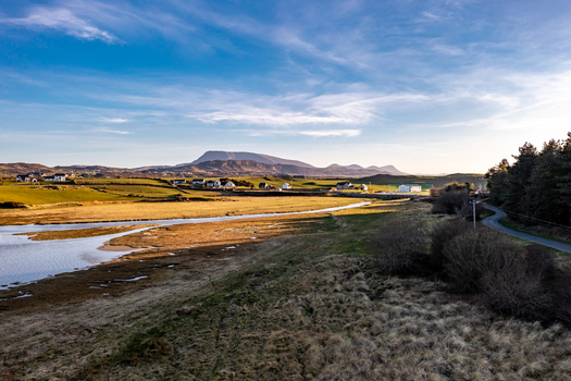 Aerial view of the tidal inlet green fields and distant mountains in the coastal landscape of Portnablagh County Donegal Ireland. Aerial view of the tidal inlet green fields and distant mountains in the coastal landscape of Portnablagh County Donegal Ireland.