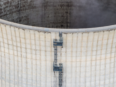 Aerial view of the cooling tower at the Heizkraftwerk Reuter West power plant featuring concrete walls with vertical ribs and metal maintenance ladders in Berlin Berlin Germany.