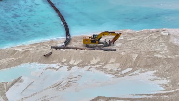 Aerial view of an excavator working on sand reclamation Maldives.
