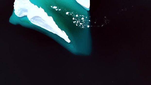 Aerial view of a large iceberg in dark arctic waters Greenland. Aerial view of a large iceberg in dark arctic waters Greenland.