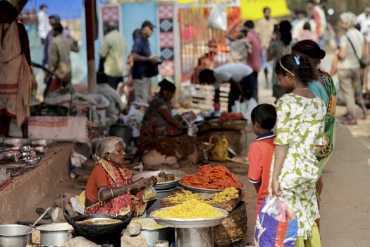 Odisha India 26 March 2026 View of a bustling market scene where vibrant colors of traditional clothing contrast with the golden hues of local snacks and the lively atmosphere of daily commerce. Odisha India 26 March 2026 View of a bustling market scene where vibrant colors of traditional clothing contrast with the golden hues of local snacks and the lively atmosphere of daily commerce.