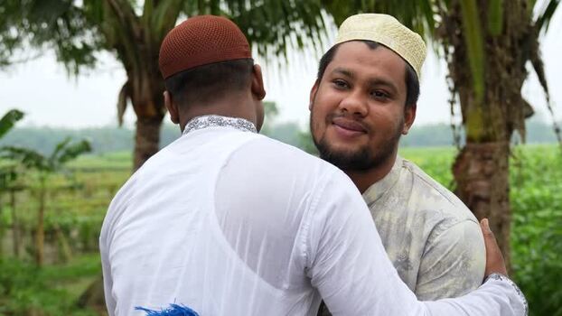 View of two Muslim men hugging during Eid in Bogura Bangladesh. View of two Muslim men hugging during Eid in Bogura Bangladesh.