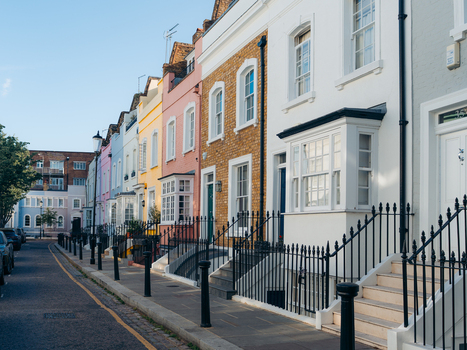 London United Kingdom 21 June 2025 View of a row of terraced houses displaying pastel hues and vibrant colors their facades catching the warm sunlight along the quiet street. London United Kingdom 21 June 2025 View of a row of terraced houses displaying pastel hues and vibrant colors their facades catching the warm sunlight along the quiet street.