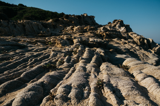 View of Tigania Beach with textured rock formations and coastal landscape in Chalkidiki Greece.