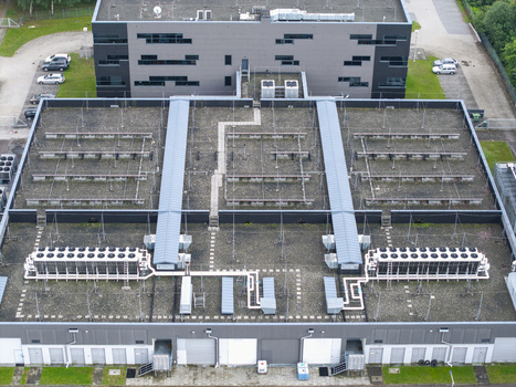 Aerial view of the ai data center cooling system with industrial HVAC units ventilation fans and piping networks on the roof of a modern facility in Krakow Lesser Poland Voivode Poland. Aerial view of the ai data center cooling system with industrial HVAC units ventilation fans and piping networks on the roof of a modern facility in Krakow Lesser Poland Voivode Poland.