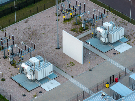 Aerial view of an advanced power substation featuring large electrical transformers gravel ground and industrial infrastructure in Warsaw Masovian Voivodeship Poland. Aerial view of an advanced power substation featuring large electrical transformers gravel ground and industrial infrastructure in Warsaw Masovian Voivodeship Poland.