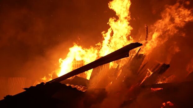 View of intense fire burning through structures at night Bangladesh. View of intense fire burning through structures at night Bangladesh.