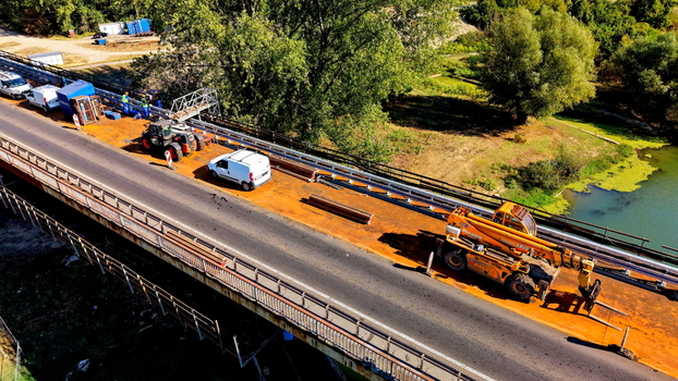 Aerial view of the Smederevo bridge and shipyard with construction vehicles and maintenance equipment on the road surface in Smederevo Podunavlje District Serbia.