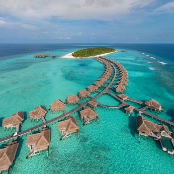 Aerial view of a turquoise dreamscape unfolds with overwater bungalows dotting the vibrant seascape near a verdant island Malé Malé Maldives. Aerial view of a turquoise dreamscape unfolds with overwater bungalows dotting the vibrant seascape near a verdant island Malé Malé Maldives.