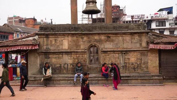 View of people at Kathmandu Durbar Square with the Big Bell Nepal.