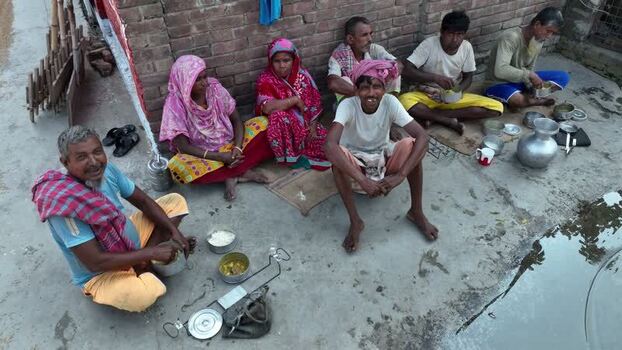 View of people eating together outdoors in Bogura Bangladesh.