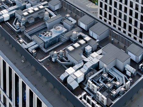 Aerial view of the rooftop of a modern office building featuring extensive HVAC systems ventilation ducts and cooling units in Krakow Lesser Poland Voivode Poland. Aerial view of the rooftop of a modern office building featuring extensive HVAC systems ventilation ducts and cooling units in Krakow Lesser Poland Voivode Poland.