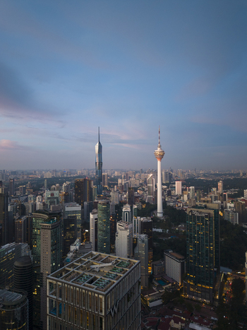 Kuala Lumpur Malaysia 11 March 2026 Aerial view of the city skyline featuring the KL Tower and Merdeka 118 skyscraper under a soft twilight sky.