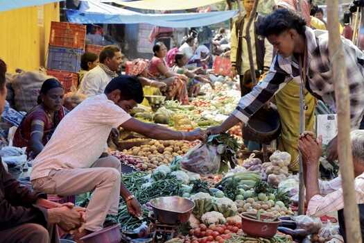 Odisha India 26 March 2026 View of a bustling marketplace overflows with vibrant produce as vendors and customers engage in lively transactions bathed in warm light. Odisha India 26 March 2026 View of a bustling marketplace overflows with vibrant produce as vendors and customers engage in lively transactions bathed in warm light.