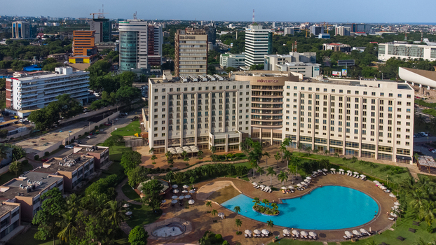 Accra Ghana 26 May 2023 Aerial view of Movenpick Ambassador Hotel Accra featuring its large swimming pool lush gardens and surrounding modern city skyline. Accra Ghana 26 May 2023 Aerial view of Movenpick Ambassador Hotel Accra featuring its large swimming pool lush gardens and surrounding modern city skyline.