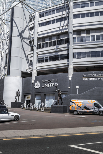 Newcastle upon Tyne United Kingdom 13 July 2026 View of St. James Park stadium featuring the Gallowgate Stand bronze statues of football legends and a parked van. Newcastle upon Tyne United Kingdom 13 July 2026 View of St. James Park stadium featuring the Gallowgate Stand bronze statues of football legends and a parked van.