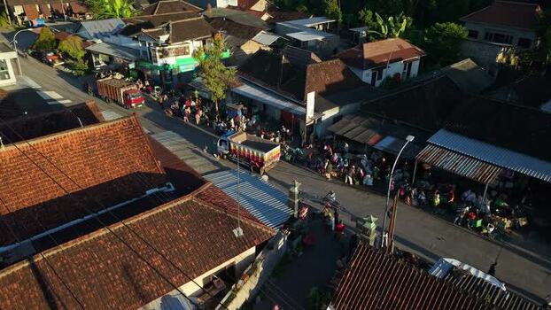 Aerial view of a busy village street with trucks Indonesia.