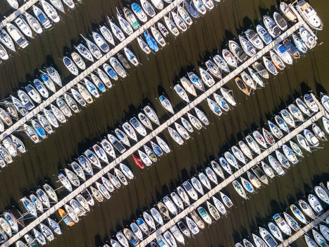 Aerial view of numerous boats docked in neat rows at a marina in Huizen North Holland Netherlands.