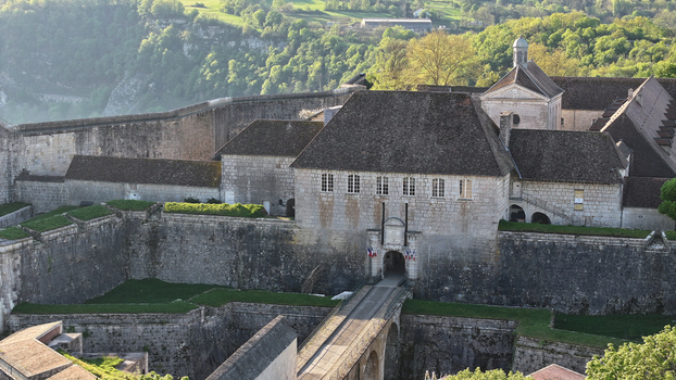 Aerial view of Besancon Citadel with its historic stone walls gatehouse and bridge surrounded by lush green hills in Besancon Bourgogne Franche Comte France. Aerial view of Besancon Citadel with its historic stone walls gatehouse and bridge surrounded by lush green hills in Besancon Bourgogne Franche Comte France.